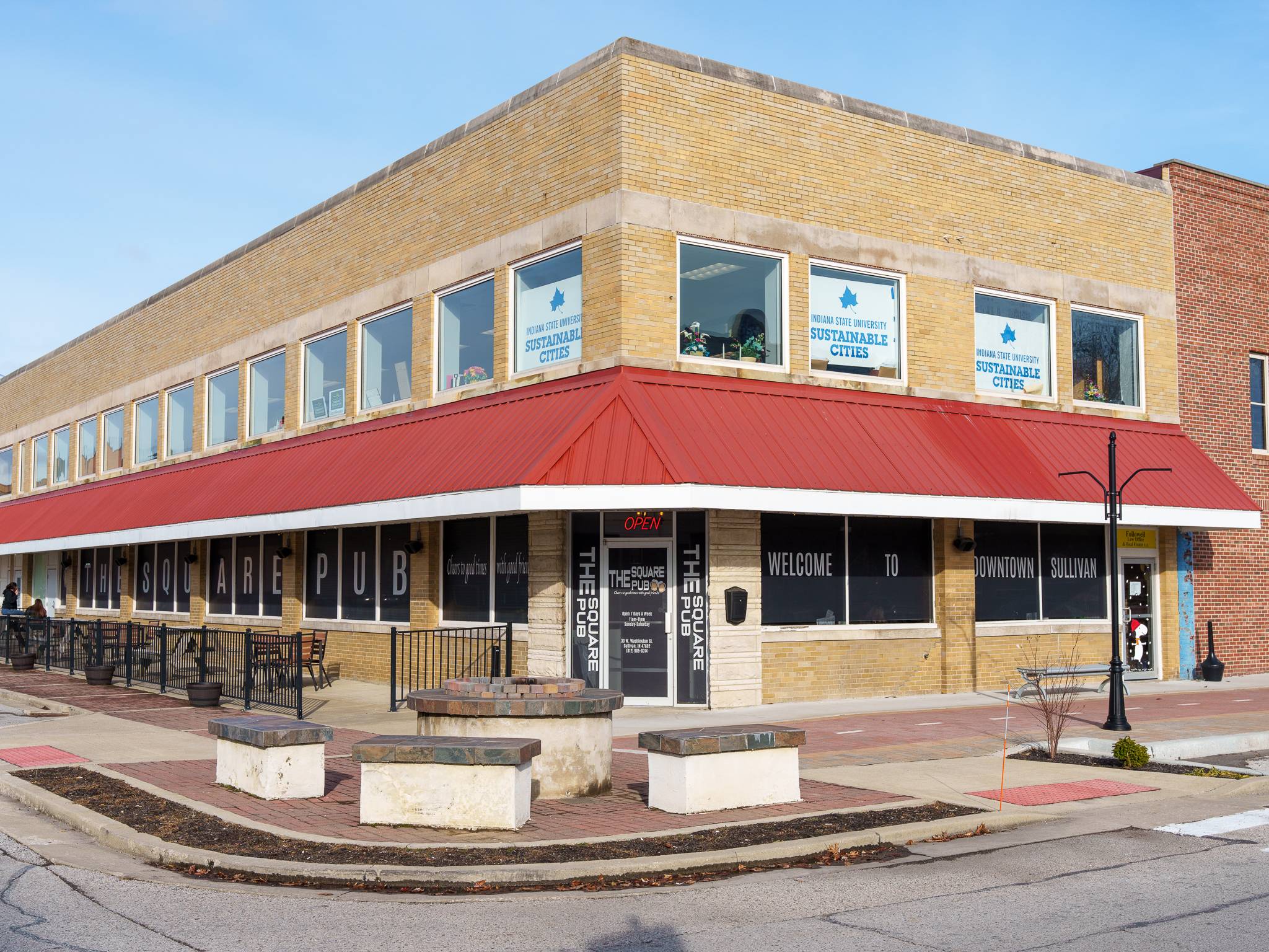 The Square Pub entrance with outside eating patio and firepit.